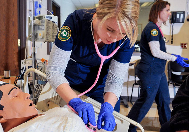 nursing student with CPR dummy